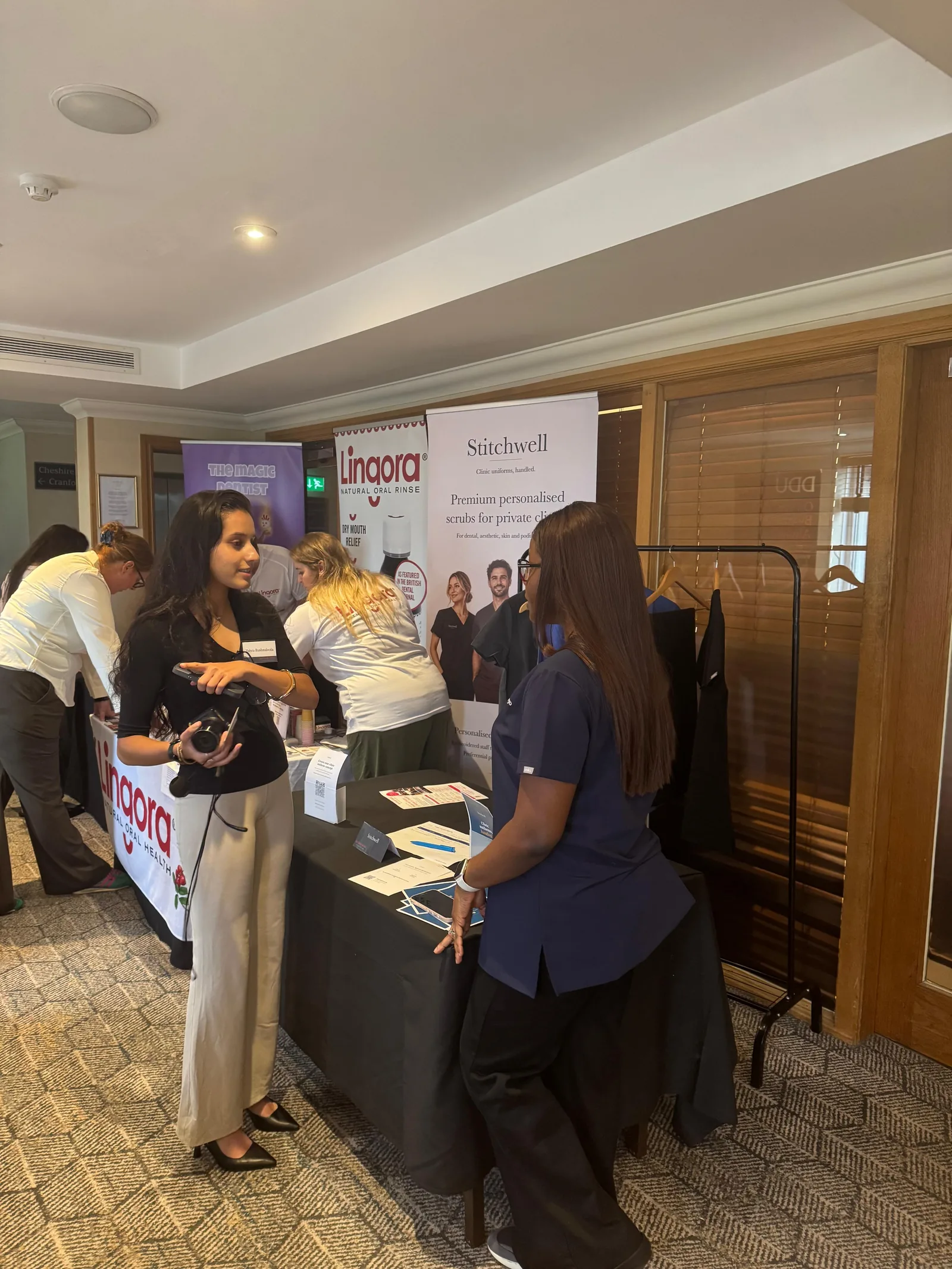 Stitchwell founder speaking with an attendee at the Force is Female North stand