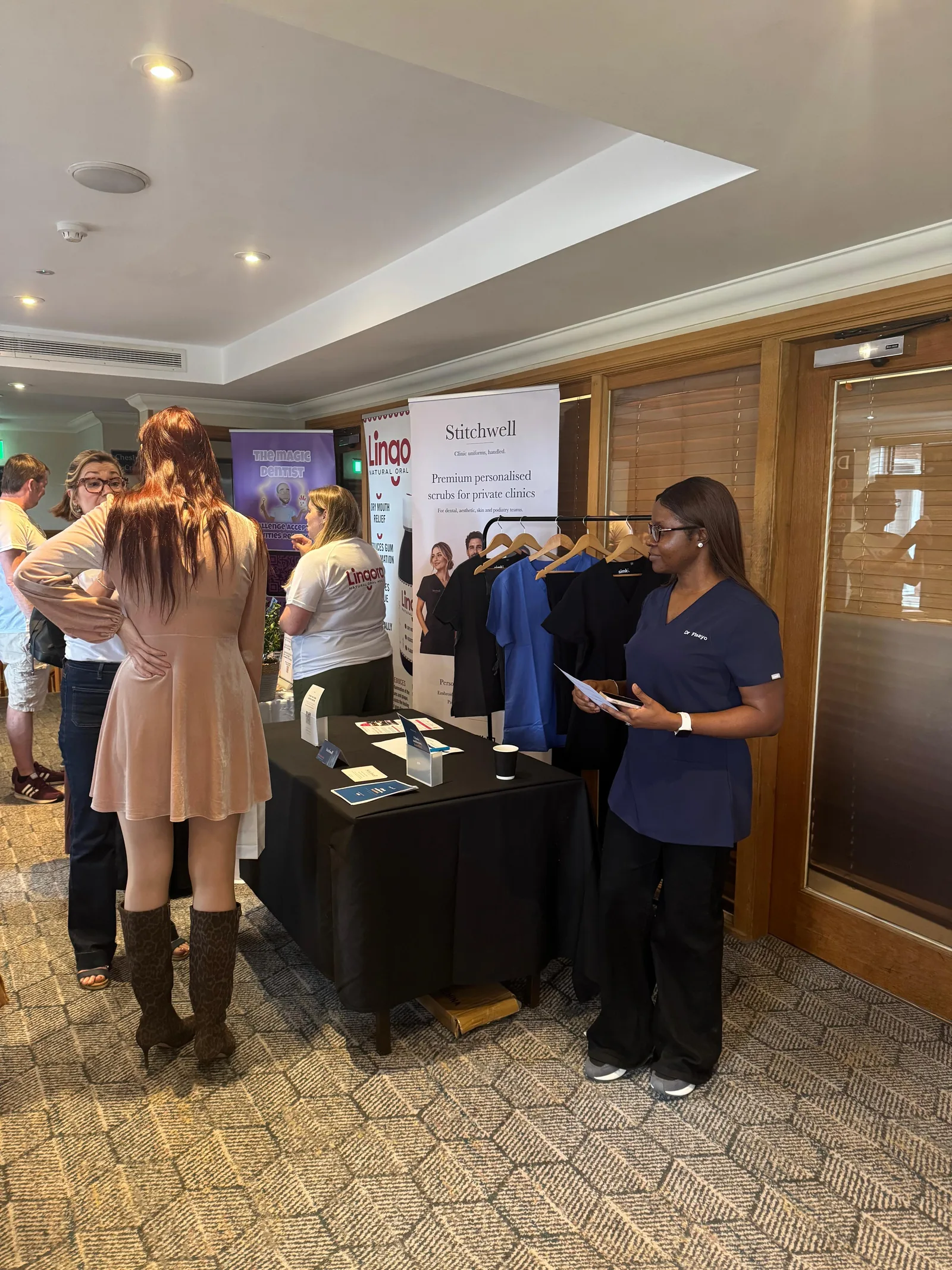Stitchwell founder talking with clinic attendees at the Force is Female North stand